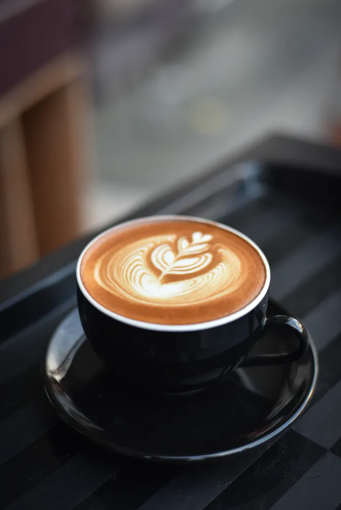 A cup of coffee served at a café table