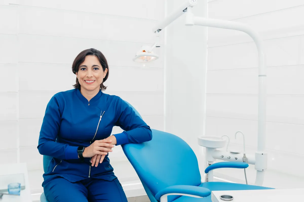 Dentist seated in a bright, modern treatment room