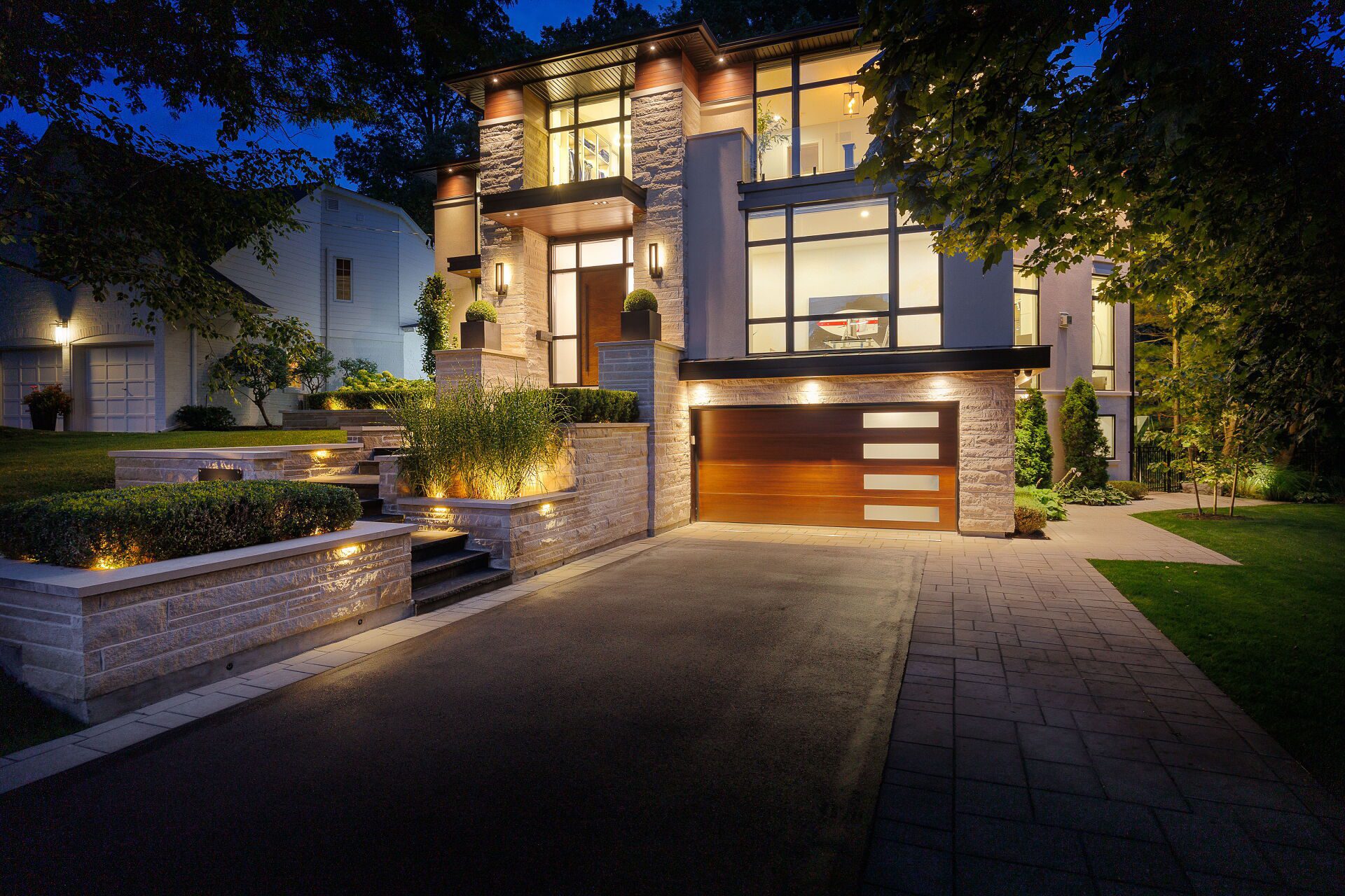 Modern detached home with warm exterior lighting