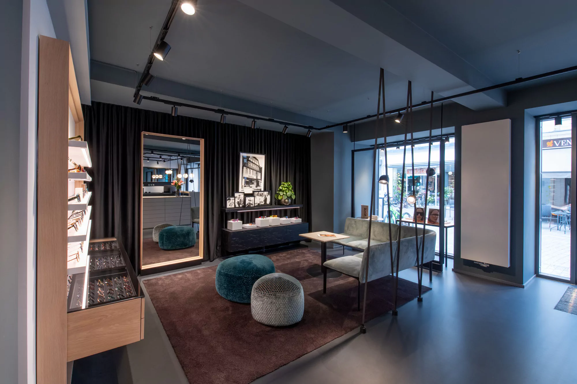 Warm, contemporary optical boutique interior with illuminated eyewear displays