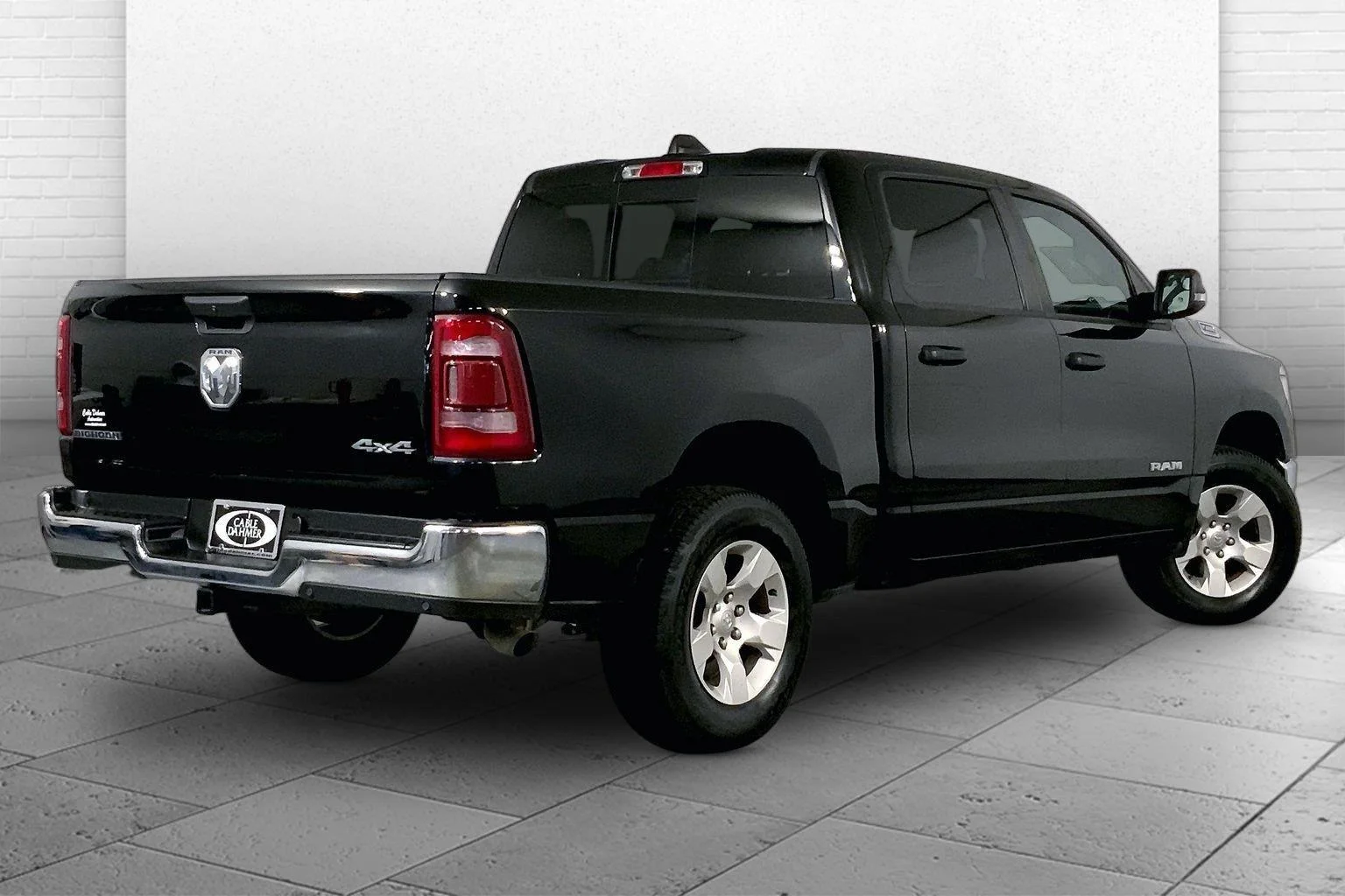 Black 2023 Ram 1500 Limited pickup photographed at a dealership