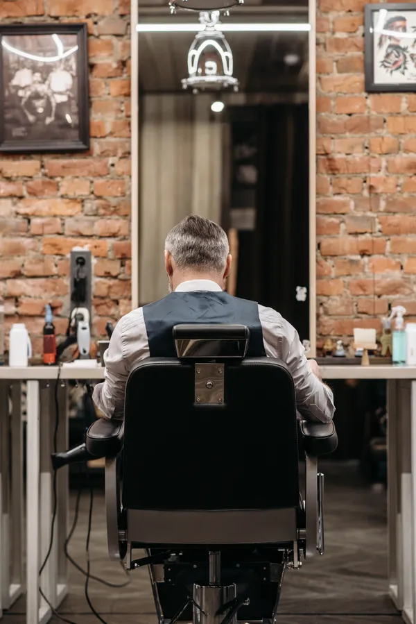 Barber styling a client's hair
