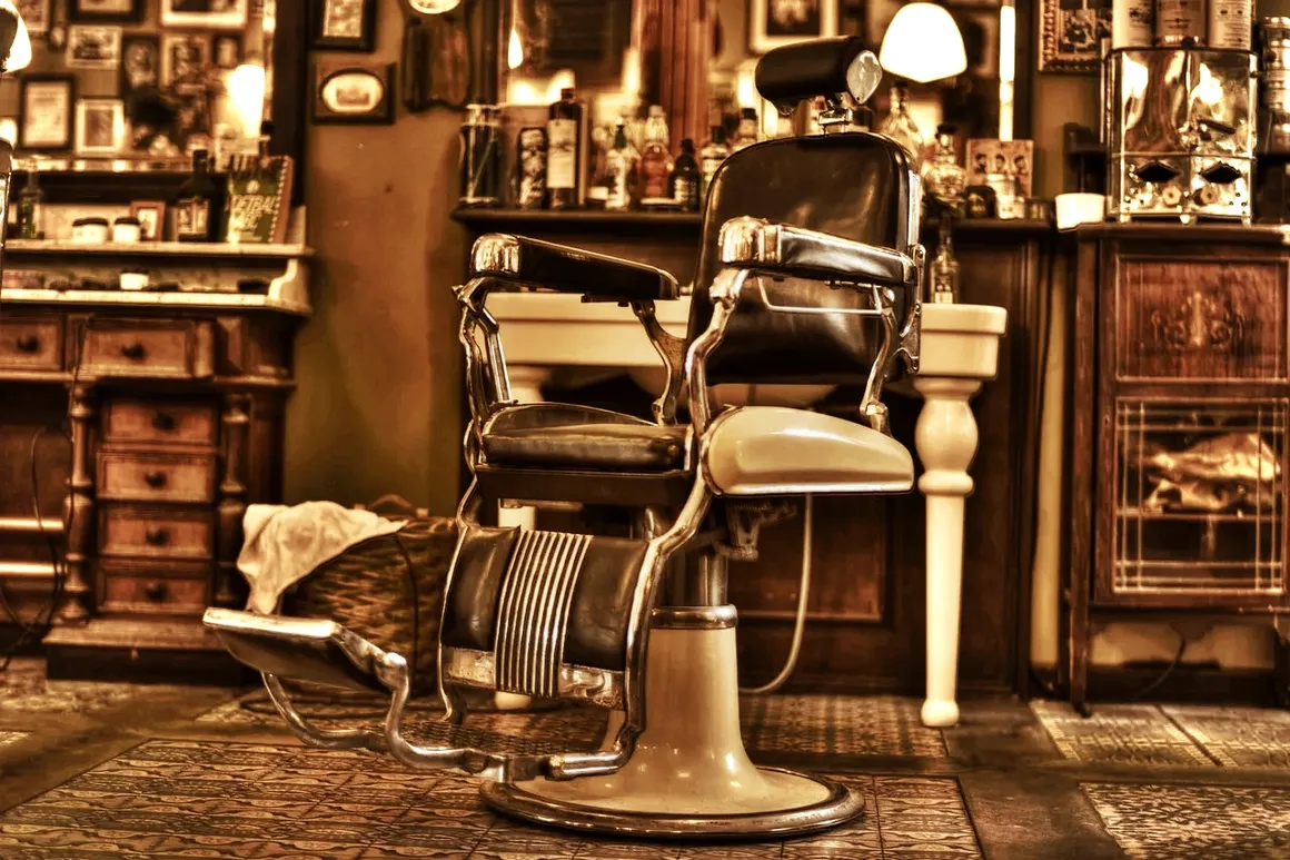Vintage leather barber chair in a traditional wood-panelled shop
